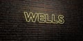 WELLS -Realistic Neon Sign on Brick Wall background - 3D rendered royalty free stock image