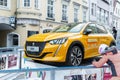 Wels, Austria - January 11th,2020: Newest Peugeot 208 gt-line 2020 model stand on basement among public skating rink in center old