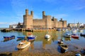 Welsh castle Caernarfon Wales with boats on calm sunny day