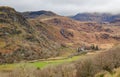 Welsh Farmhouse nestling in the valley under the mountains with an overcast sky Royalty Free Stock Photo