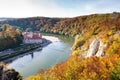 Weltenburg monastery and Donaudurchbruch at the Danube river in Bavaria, Germany surrounded by orange autumn colored