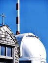 Wendelstein, Germany - telecommunication 5g antenna and cross chapel on blue sky background Royalty Free Stock Photo