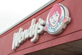 tor, canada - august 10, 2023: wendys restaurant logo on building store exterior outside in summer. p