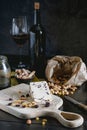 Wensleydale cheese with cranberries, red wine, honey, nuts, raisins on wooden cutting board Royalty Free Stock Photo