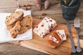 Wensleydale cheese with cranberries, red wine, honey, nuts, raisins on wooden cutting board. Black concrete background Royalty Free Stock Photo