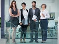 Were aiming for excellence. Portrait of a group of businesspeople standing together in a modern office. Royalty Free Stock Photo