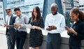 Were all on the same meeting next to each other. businesspeople using various devices against an urban background. Royalty Free Stock Photo