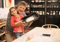 Were the best baking team ever. Portrait of a little girl and her grandfather baking together. Royalty Free Stock Photo