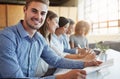 Were the best team in the business. Cropped portrait of a young businessman working in the office with his colleagues. Royalty Free Stock Photo