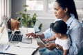 Were both working really hard. a young mother caring for her baby girl while working from home. Royalty Free Stock Photo