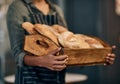 Were the bread to your gravy. a woman holding a selection of freshly baked breads in her bakery. Royalty Free Stock Photo
