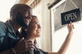 Were in for a busy day, babe. Shot of a young couple standing together and turning the sign on the door to their bicycle Royalty Free Stock Photo