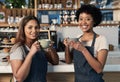 Were geeks about coffee. Portrait of two young women drinking coffee together while working in a cafe.