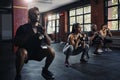 Were getting stronger together. young people working out in the gym.