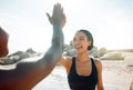 Were going to kick this workouts butt. two friends high fiving after a workout.