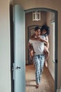 Were having a fun filled morning. Full length shot of a young man carrying his girlfriend piggy back while spending some Royalty Free Stock Photo