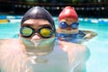 Were at home in the water. Two young swimmers with their faces half subrnerged in the water. Royalty Free Stock Photo