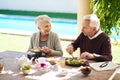 Were living a happy and healthy life. an affectionate senior couple enjoying a meal together outdoors. Royalty Free Stock Photo