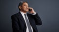 Were looking at a smarter future. Studio shot of a mature businessman talking on his cellphone. Royalty Free Stock Photo