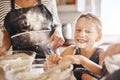 Were making memories, not a mess. Portrait of a little girl having fun while baking with her family in the kitchen. Royalty Free Stock Photo