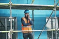 Were moving along right on track. Shot of a young man talking on a cellphone while working at a construction site. Royalty Free Stock Photo
