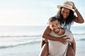 Were simply loving our day out in the sun. Portrait of a young man piggybacking his girlfriend at the beach. Royalty Free Stock Photo