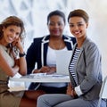 Were taking the office by storm. Portrait of a group of smiling businesswomen sitting in an office. Royalty Free Stock Photo