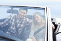 Were taking the road less travelled...A happy couple taking a road trip in a convertible. Royalty Free Stock Photo