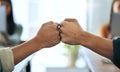 Were two of a kind. two unrecognizable businesspeople sitting together in the office and giving each other a fist bump.
