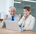 Were winning. surprised colleagues looking at a laptop in a boardroom. Royalty Free Stock Photo