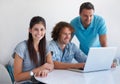 Were working on something big. three coworkers gathered around a laptop in the office. Royalty Free Stock Photo