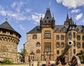 Wernigerode castle with a medieval cannon and a fountain in the foreground