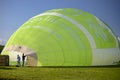 Wershofen, Germany  03 September 2017. Preparing a green hot air balloon for flight by heating the air with a gas burner. The ball Royalty Free Stock Photo