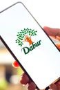 West Bangal, India - October 09, 2021 : Dabur logo on phone screen stock image.