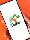 West Bangal, India - October 09, 2021 : Dabur logo on phone screen stock image.