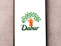 West Bangal, India - October 09, 2021 : Dabur logo on phone screen stock image.