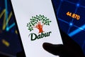 West Bangal, India - October 09, 2021 : Dabur logo on phone screen stock image.