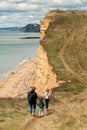 08-29-2020 West Bay, UK. Family enjoying walking on top of Jurassic Cliffs on sunny summer day. Royalty Free Stock Photo