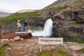 Unidentified tourists taking picture of small waterfall near Dynjandi Waterfall,Iceland.