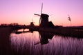 West Friesland, Netherlands, April 2015: Windmills in silhouette in the evening.