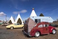 Vintage camping car parked in front of iconic concrete tipis of the 1937 Wigwam Motel Royalty Free Stock Photo