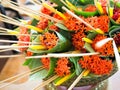 West Indian Jasmine or Ixora, incense stick and candles in banana-leaf cone being prepared for a National Teacher`s Day Wai Kru