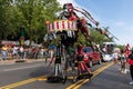 West Indian Labor Day Parade with a man in a beautiful costume, cars and large crowds