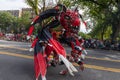 West Indian Labor Day Parade with a man in a red dragon costume and large crowds