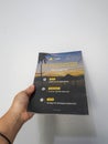 West Java in August 2022. A hand holds the Indonesian version of the National Geographic magazine