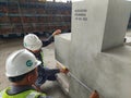 West Java, Purwakarta - June 10, 2023: Workers take measurements on concrete using a meter