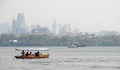 West Lake Xi Hu in Hangzhou, Zhejiang Province, China. Boats on the lake with the city behind.