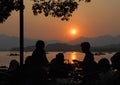 West Lake Xi Hu sunset in Hangzhou, Zhejiang Province, China with silhouettes of people. Royalty Free Stock Photo