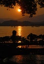 West Lake Xi Hu sunset in Hangzhou, Zhejiang Province, China with silhouettes of a person. Royalty Free Stock Photo
