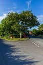 West Lulworth, Dorset / United Kingdom - June 20, 2019: A view of a rural village road intersection with letter box, phone boot Royalty Free Stock Photo